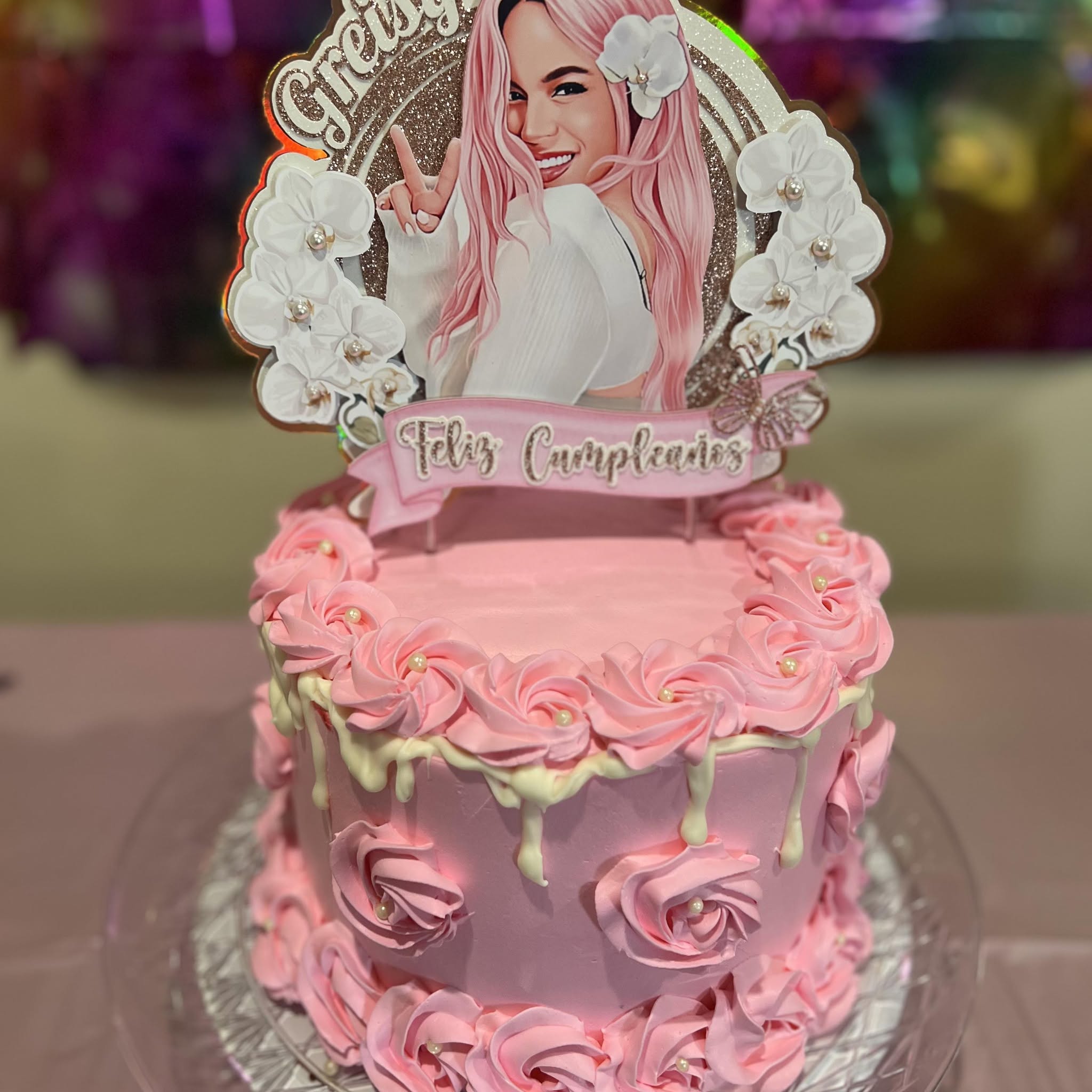Pink rose-piped birthday cake with pearls, white chocolate drip and a Feliz Cumpleaños topper